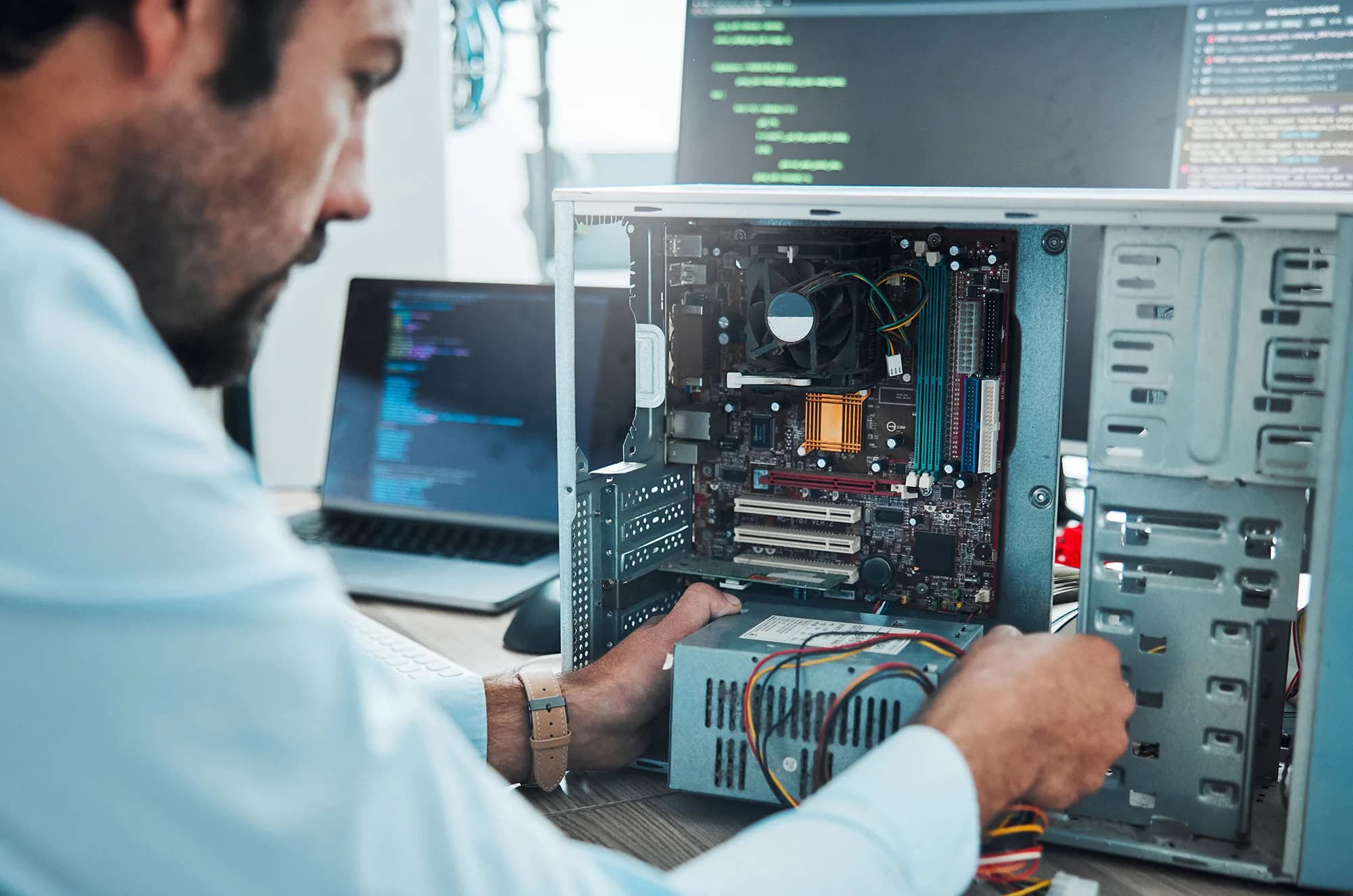 Technician evaluating a desktop computer for reuse or recycling in Miami